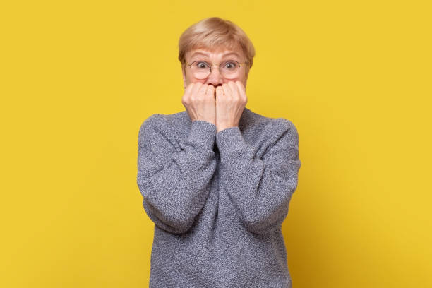 istock Scared worried mature caucasian woman, biting nails. 1296727762