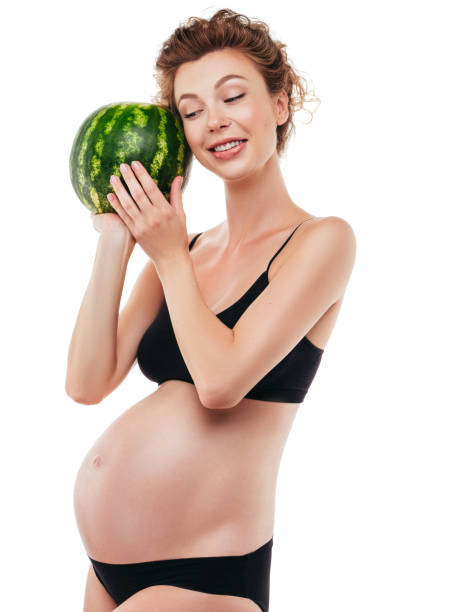 istock Pregnant woman holding a watermelon 1296730206