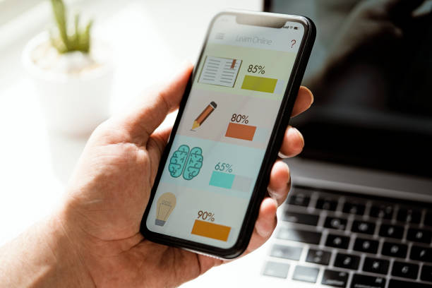istock Hand holding phone, online learning app on phone screen 1296730306