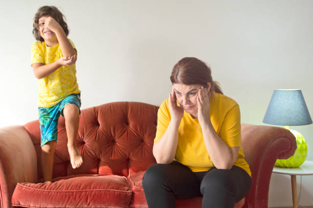 istock Tired mother sitting on couch feels annoyed 1296731144