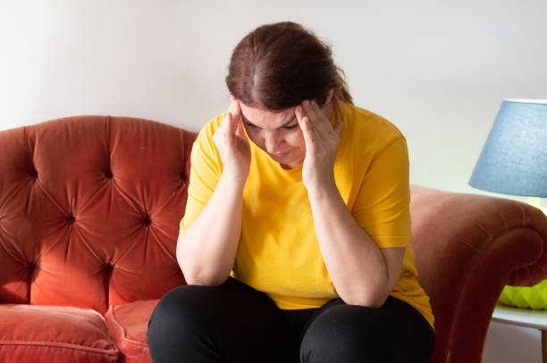 istock Tired mother sitting on couch feels annoyed 1296731181