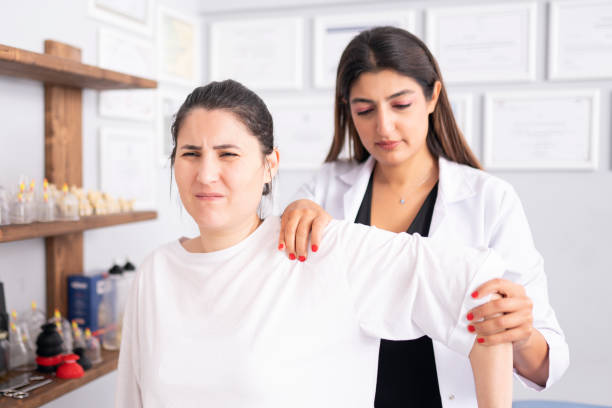istock Female physiotherapist is examining to her patient. 1296732259