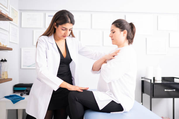 istock Female physiotherapist is examining to her patient. 1296732283