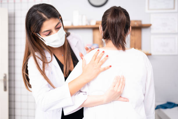 istock Female physiotherapist is examining to her patient. 1296732291