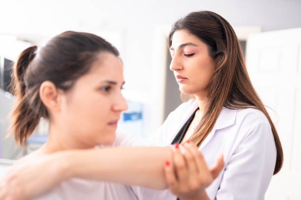 istock Female physiotherapist is examining to her patient. 1296732305