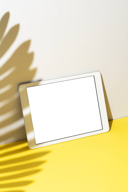istock Blank screen digital tablet mockup, template on yellow and white background 1296732327