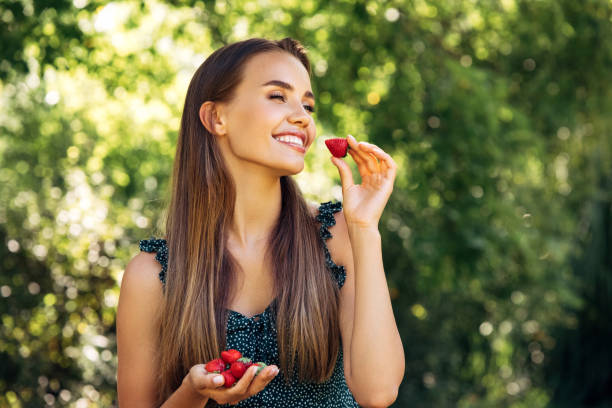 istock Enjoying sunny day wile eating strawberry 1296734527