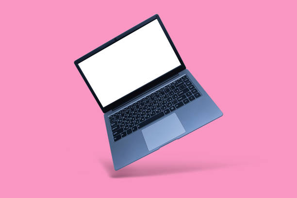 istock Slim modern laptop with white screen mockup on pink background with shadow. 1296734570