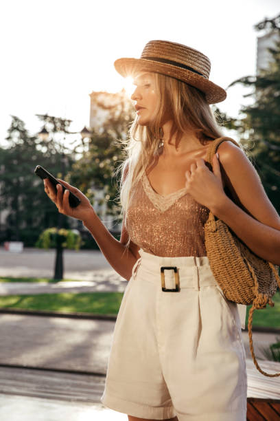 istock Beautiful girl outdoors with smart phone 1296734714