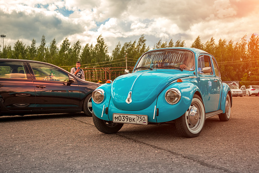 Moscow, Russia - July 06, 2019: Volkswagen KÃ¤fer 1303. Type 1 Vintage VW Beetle was produced since 1946. A blue retro car stands in the parking lot with a driver inside. Front view