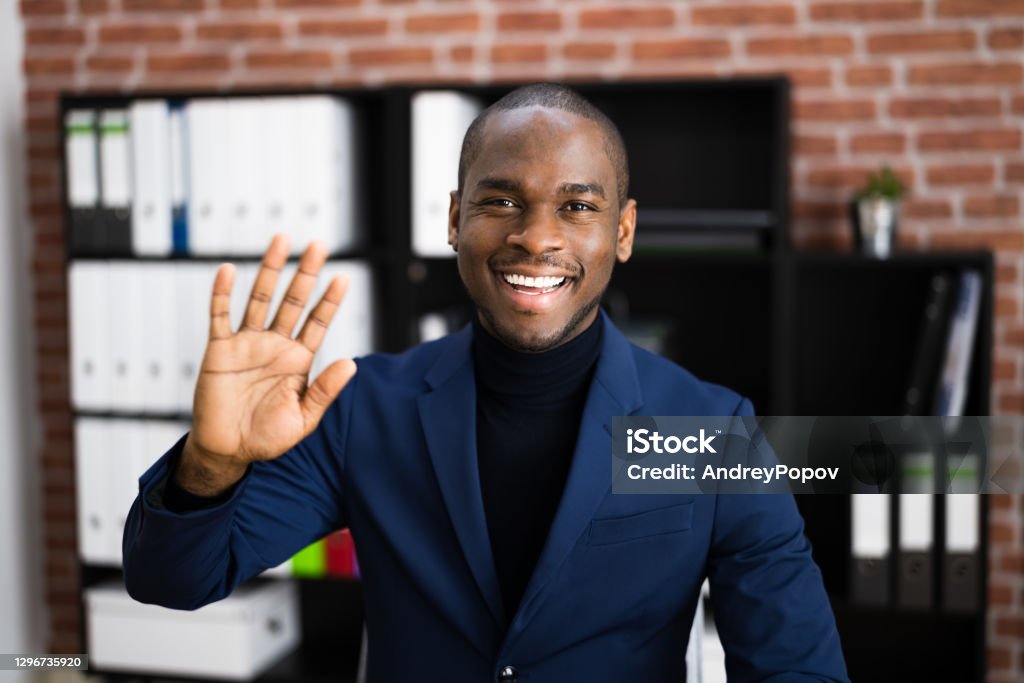 African American Elearning Videoconference African American Elearning Videoconference In Office Waving Hand Leaving Stock Photo