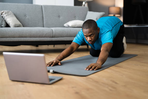 istock African American Doing Online Stretching Fitness Workout Class 1296737062