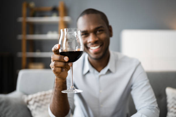 istock Man Drinking Red Wine In Video Conference 1296737088