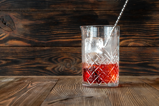 Glass of Boulevardier cocktail in mixing glass
