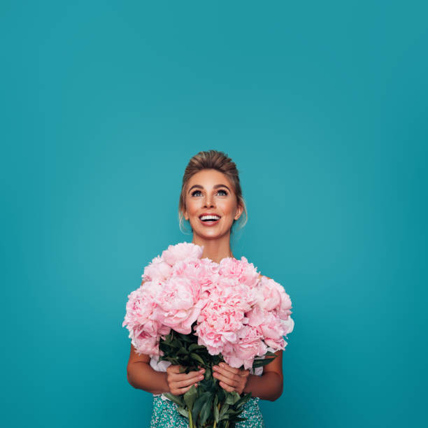 istock Beautiful woman with flowers 1296739231