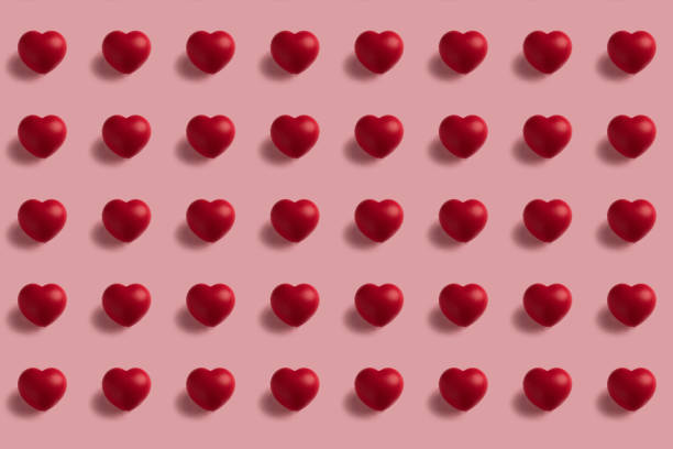 istock Seamless pattern of red hearts on pink background 1296739267
