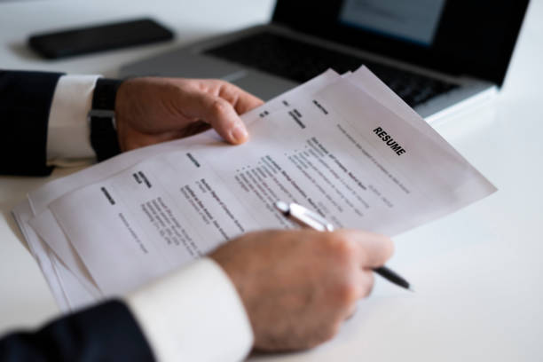 istock Business man review his resume application on desk 1296739311