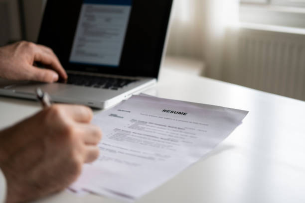 istock Business man review his resume application on desk 1296739312