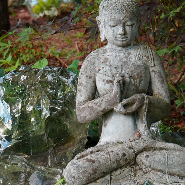 istock Meditating Buddha in the garden 1296741437