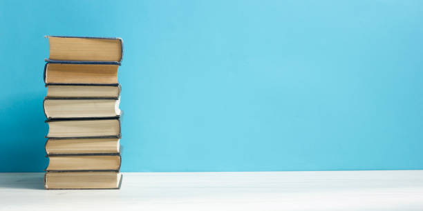 istock Books on wooden desk table and abstract background. Education background. Copy Space. Back to school. 1296745214