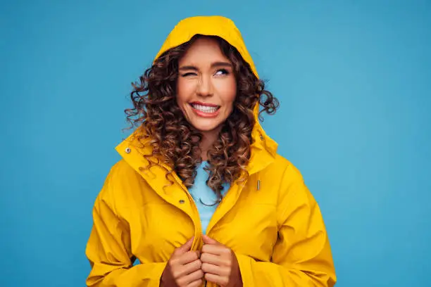 Smiling beautiful woman in raincoat