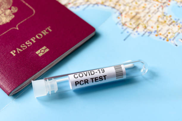 COVID-19, travel and test concept, tube for PCR testing and tourist passport on geographic map COVID-19, travel and test concept, tube for PCR testing and tourist passport on geographic map. Coronavirus diagnostics in airport due to pandemic. Tourism and business hit by SARS-Cov-2 corona virus pcr device stock pictures, royalty-free photos & images