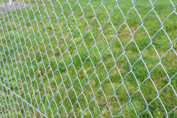 istock side view to a metal chain-link fence 1296748244