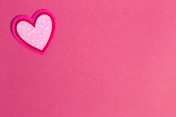 istock Simple Background with Felt Love Hearts on a Pink Background 1296749243