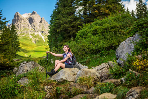 istock Female hiker in the alpine mountain countryside 1296751003