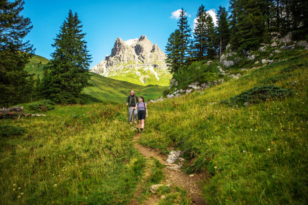 istock Two hikers in the alpine mountain countryside 1296751050