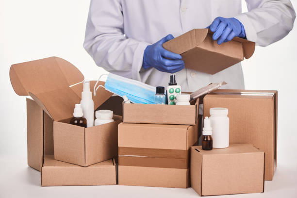 istock Pharmacist packing ordered medications and supplies into cardboard boxes 1296751200