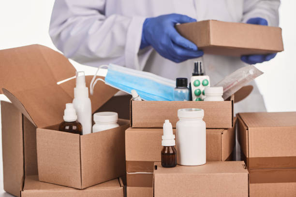 istock Various medicines being packed into cardboard boxes by a pharmacist 1296751215