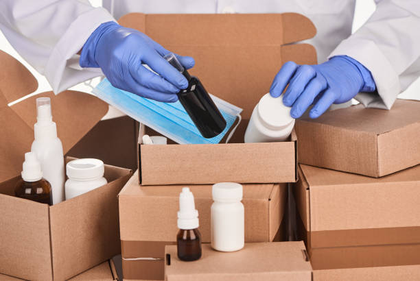 istock Pharmacist putting medicines into cardboard boxes for delivery 1296751236