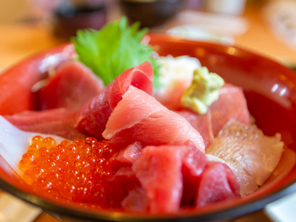 istock Bowl of rice topped with sashimi 1296755454