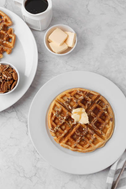 istock Homemade Pecan Waffles on White Countertop 1296758787