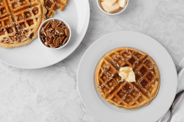 istock Homemade Pecan Waffles on White Countertop 1296758789