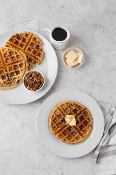 istock Homemade Pecan Waffles on White Countertop 1296758791