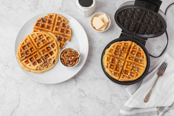 istock Homemade Pecan Waffles on White Countertop 1296758792