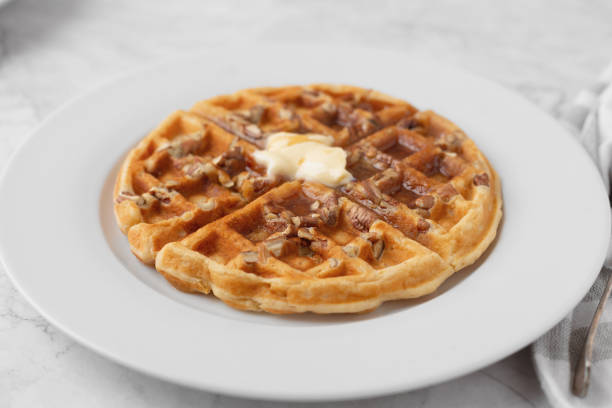 istock Homemade Pecan Waffles on White Countertop 1296758794