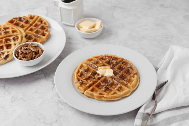 istock Homemade Pecan Waffles on White Countertop 1296758795