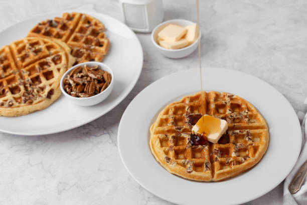 istock Homemade Pecan Waffles on White Countertop 1296758796