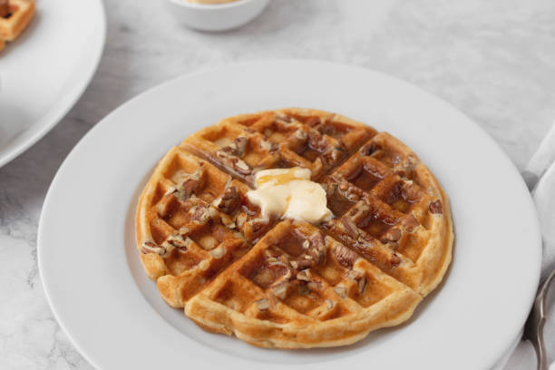 istock Homemade Pecan Waffles on White Countertop 1296758797