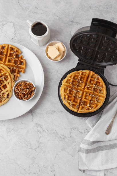istock Homemade Pecan Waffles on White Countertop 1296758799