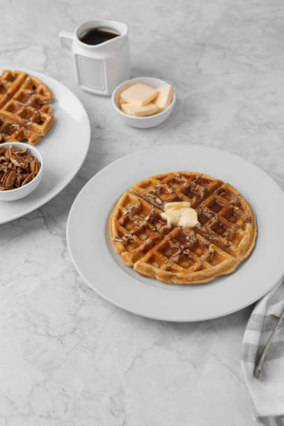 istock Homemade Pecan Waffles on White Countertop 1296758801