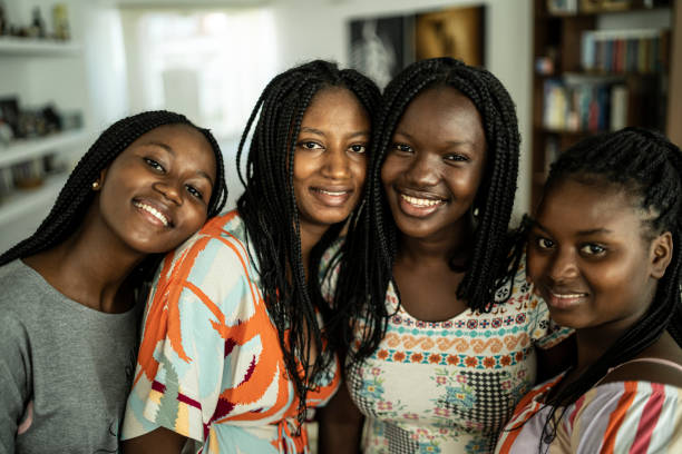 istock Four girlfriends embracing and taking selfie 1296760830