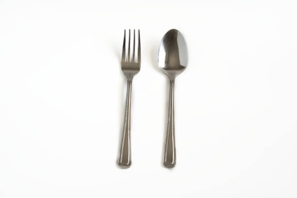 istock Metal spoon and fork isolated on white background. 1296760878