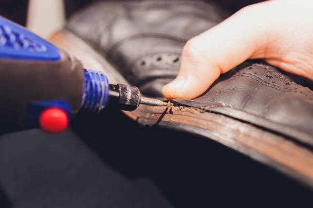 istock A shoemaker cuts the sole of a Shoe with a shoemaker's automatic cutter. 1296761672