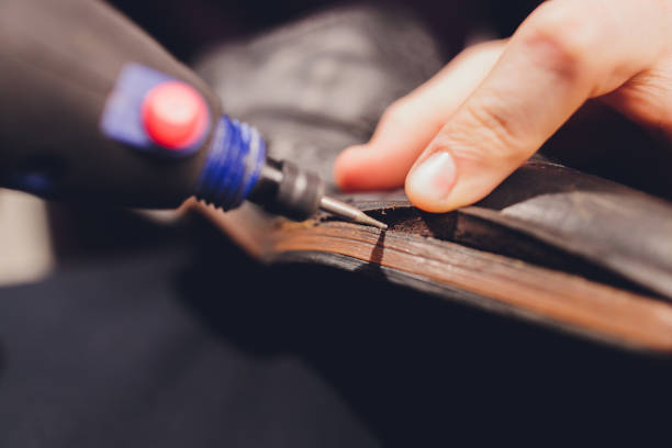 istock A shoemaker cuts the sole of a Shoe with a shoemaker's automatic cutter. 1296761674