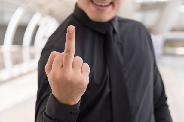 istock man showing middle finger, rude hand sign 1296762062