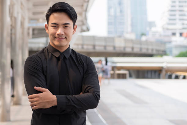 istock confident, happy, successful asian businessman arm crossing 1296762073